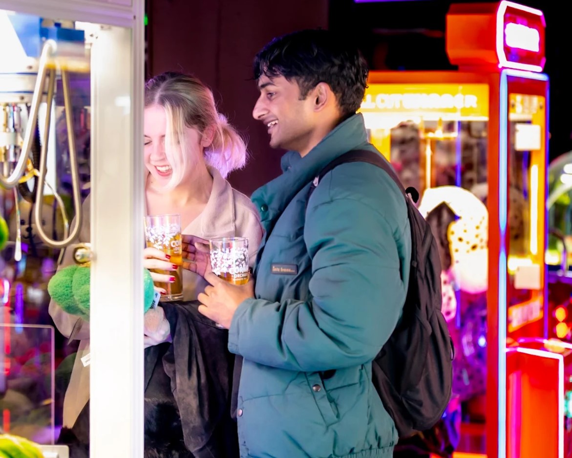 Woman and man at grabby machines